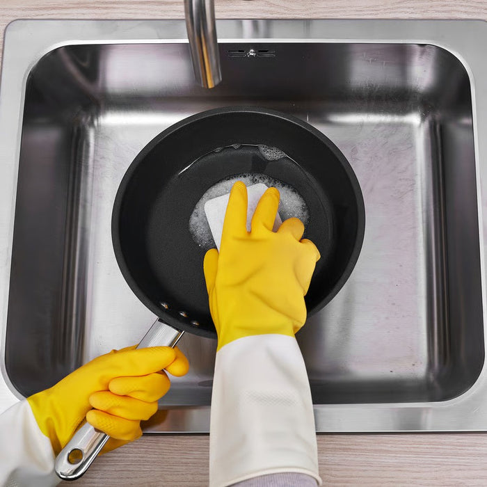 A pair of durable rubber cleaning gloves in bright yellow with an off-white cuff, designed for household chores and wet tasks.