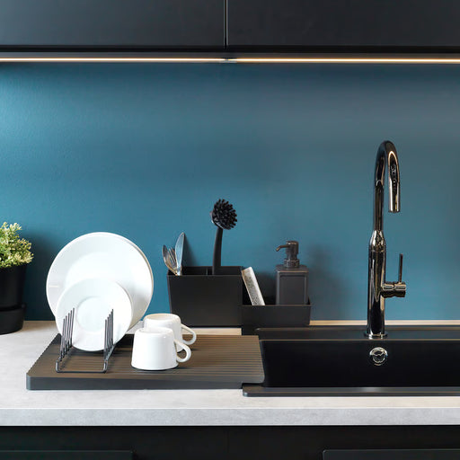 IKEA RINNIG plate holder in use at kitchen sink holding nine plates, double-sided dish drainer setup