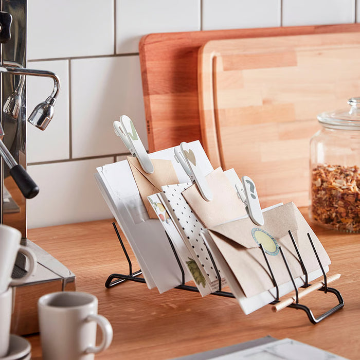 IKEA RINNIG plate holder used as card and letter organiser on kitchen counter beside coffee machine