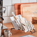 IKEA RINNIG plate holder used as card and letter organiser on kitchen counter beside coffee machine