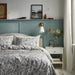 IKEA RODGERSIA grey white paisley duvet cover styled on bed in cosy bedroom setting