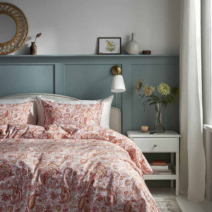 IKEA RODGERSIA pink paisley bedding styled on bed in bedroom with teal headboard and mirror