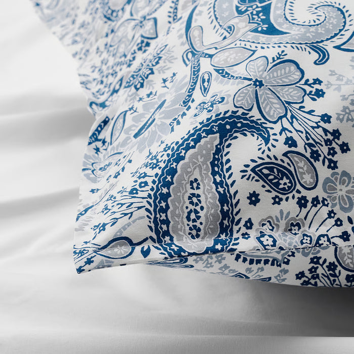 Close-up of IKEA RODGERSIA blue paisley pattern on white fabric showing soft sheen and fine weave detail