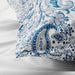 Close-up of IKEA RODGERSIA blue paisley pattern on white fabric showing soft sheen and fine weave detail