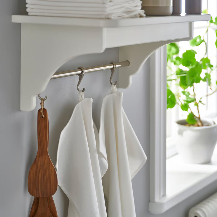  IKEA RÖDSPÄTTA white tea towels hanging on kitchen shelf rail next to wooden spatula and plant