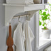  IKEA RÖDSPÄTTA white tea towels hanging on kitchen shelf rail next to wooden spatula and plant