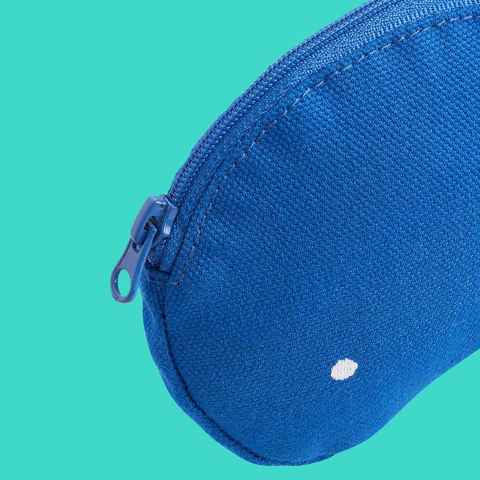 Close-up of IKEA ROMELSÖN blue recycled polyester zip accessory bag on teal background