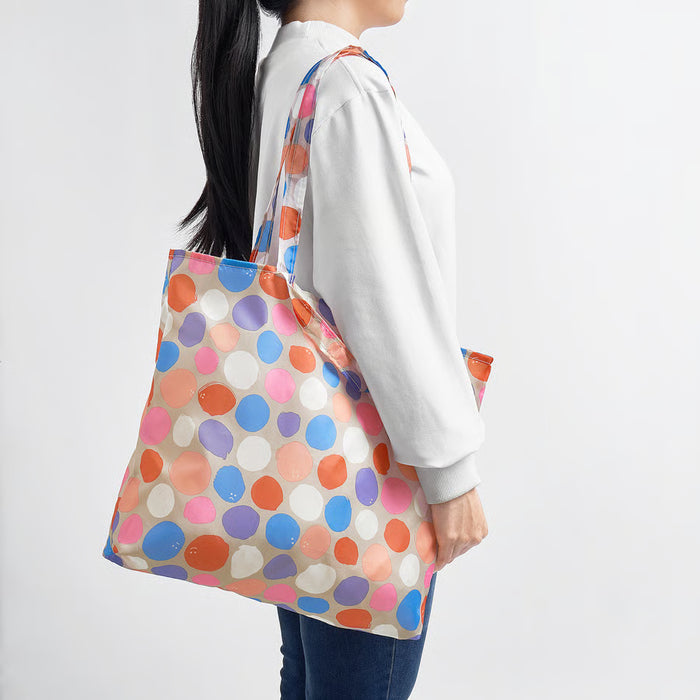 Person wearing IKEA ROMELSÖN bright polka dot bag over shoulder in everyday carry setting