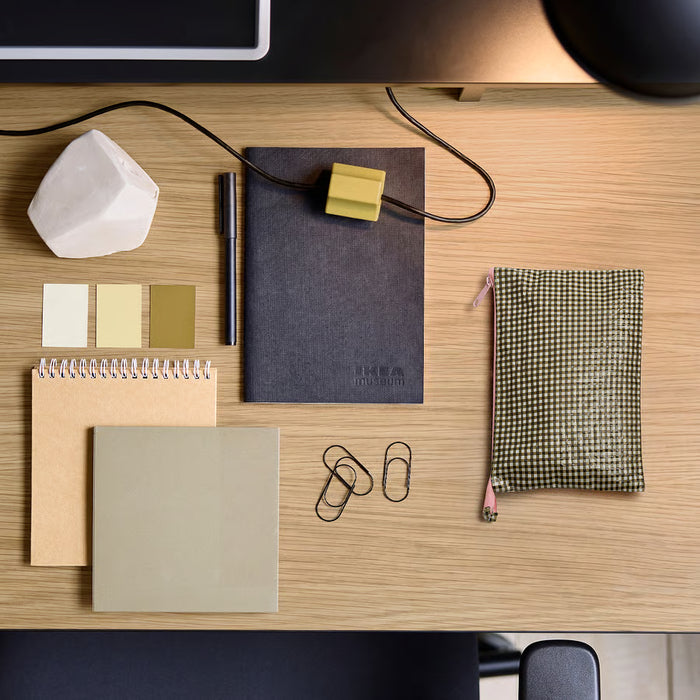 IKEA ROMELSÖN black and white check case on wooden desk with notebooks and paper clips