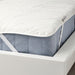 Mattress with a white cover on a white bed frame