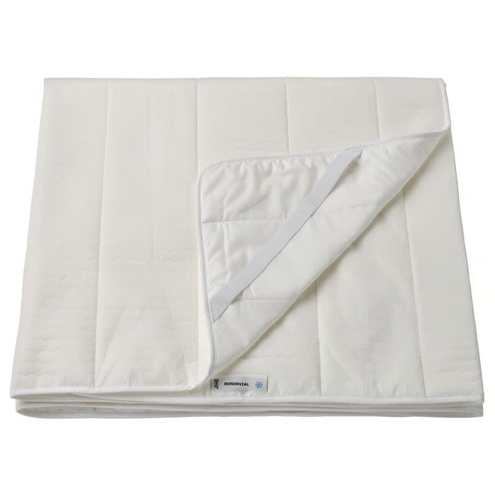 White quilt with a visible brand label on a white background