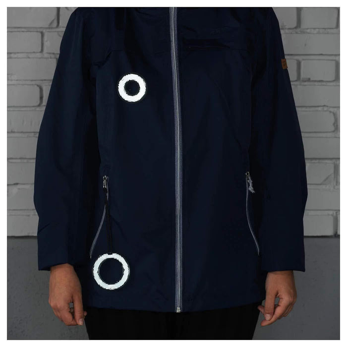 IKEA BESKYDDA reflective pin attached to jacket lapel close-up showing reflective surface detail