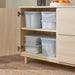  IKEA RYKTA grey-blue storage boxes with lids stacked on two shelves of wooden cabinet showing stackable design