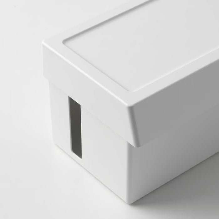 IKEA SÄTTING cable box on desk with smartphone charging wirelessly and notepad nearby