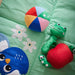 Baby playing with IKEA SANDBI multicolour jingling ball toy