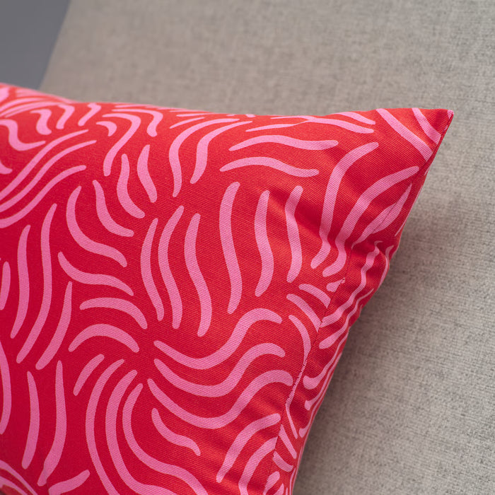 Close-up of IKEA SANDMOTT cushion red pink swirl fabric texture cotton detail
