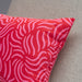 Close-up of IKEA SANDMOTT cushion red pink swirl fabric texture cotton detail