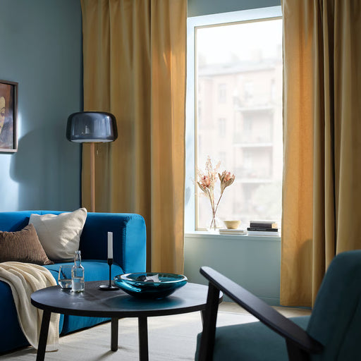 IKEA SANELA beige-yellow curtains in modern living room with teal sofa and round table