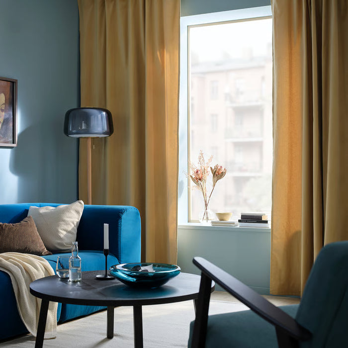 IKEA SANELA beige-yellow curtains in modern living room with teal sofa and round table