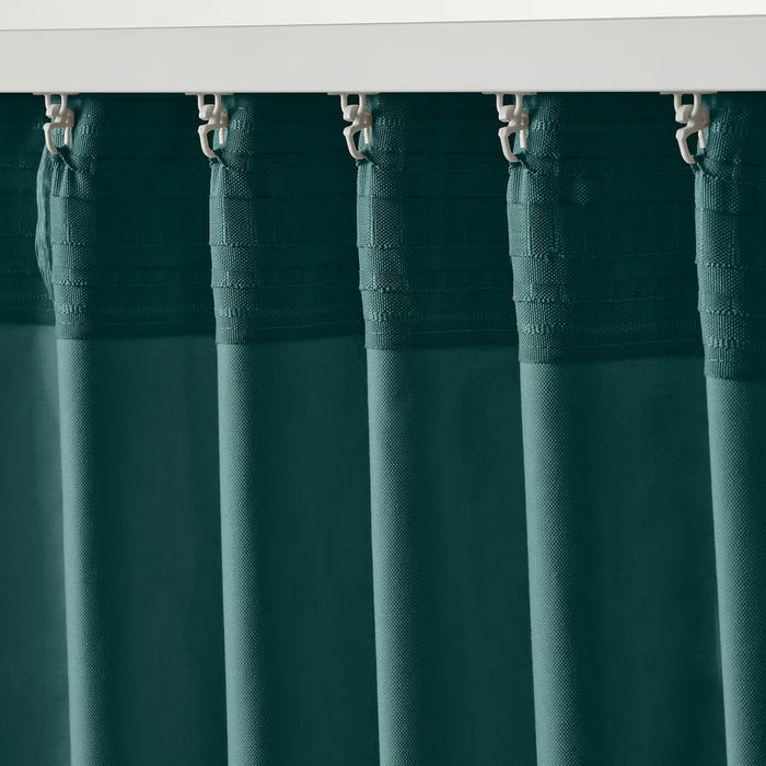 Person hanging IKEA SANELA velvet curtains on a rod, installation step shown
