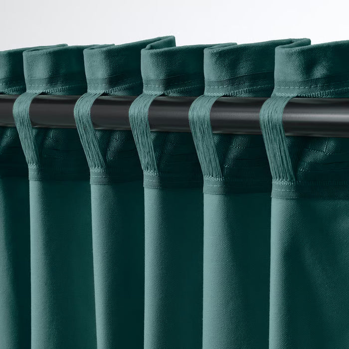 SANELA curtains hanging from white hooks showing pleats for room-darkening privacy
