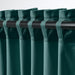 SANELA curtains hanging from white hooks showing pleats for room-darkening privacy