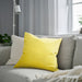 IKEA SANELA light yellow cushion cover styled on grey sofa near window
