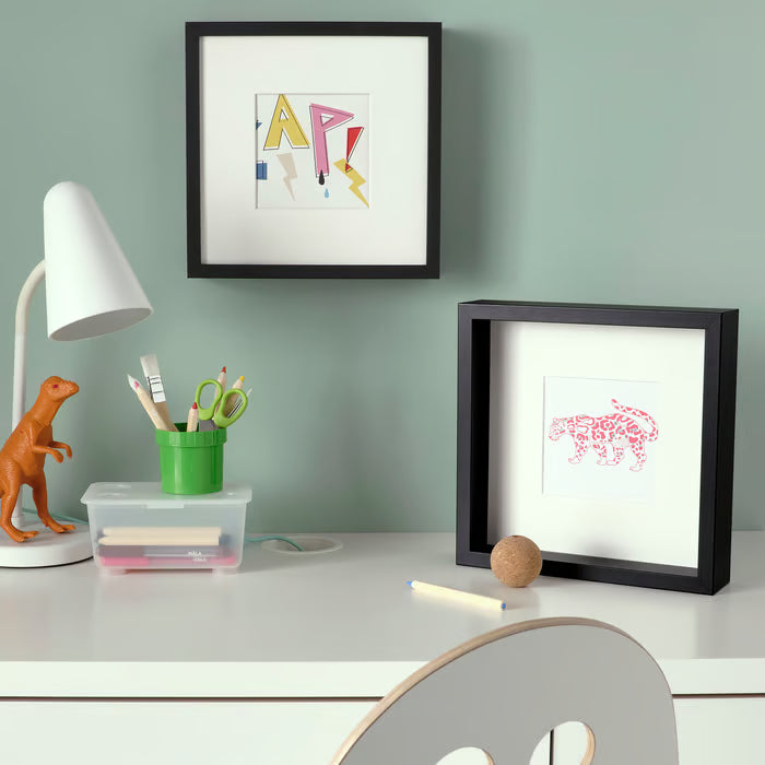  IKEA SANNAHED black frame standing vertically on a shelf displaying a 25x25 cm photograph