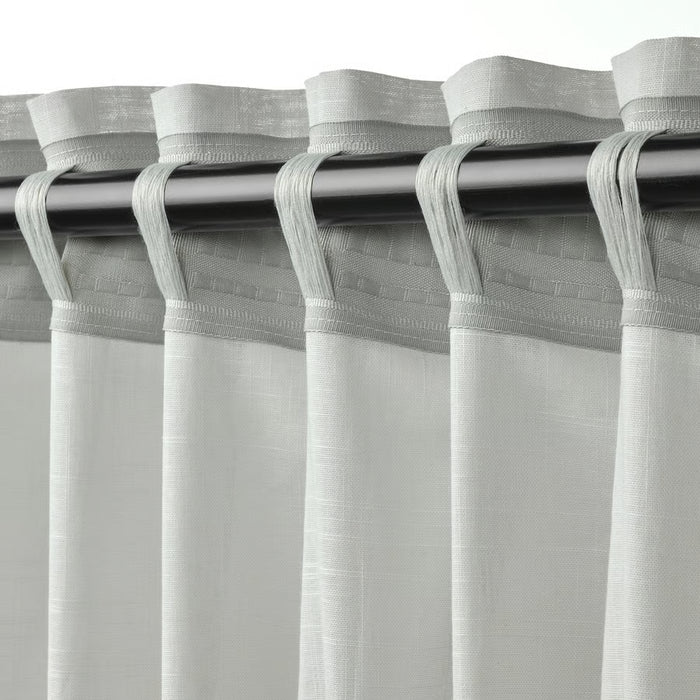 Close-up of IKEA SILVERLÖNN heading tape clips designed for creating neat pleats