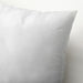 IKEA SJUKSYSTER pillow plump comfort styled on white bed close view