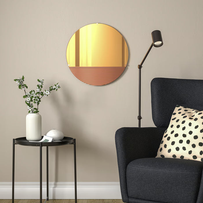IKEA SKOGSGRÄNSEN rose-gold mirror mounted above wooden chair in bedroom