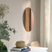 IKEA SKOGSGRÄNSEN copper mirror beside grey armchair and side table decor
