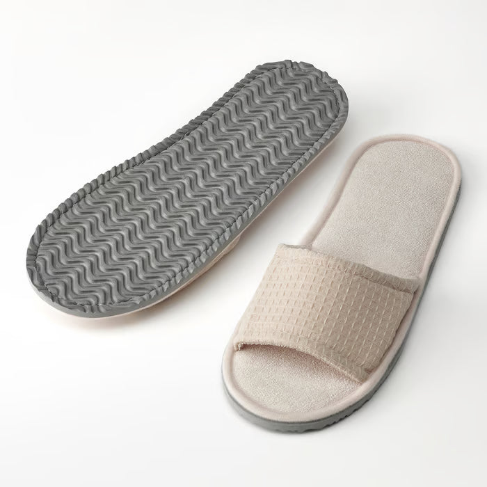 IKEA SKOVELSJÖN beige slipper side view showing cushioned EVA foam sole and open-toe design