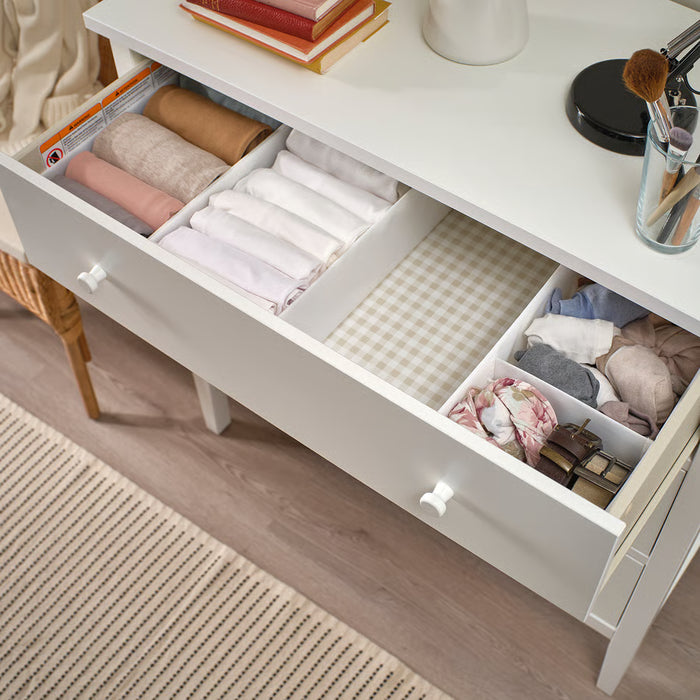 IKEA SKUBB white fabric box placed inside a chest of drawers