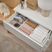 IKEA SKUBB white boxes organising folded clothes in a drawer