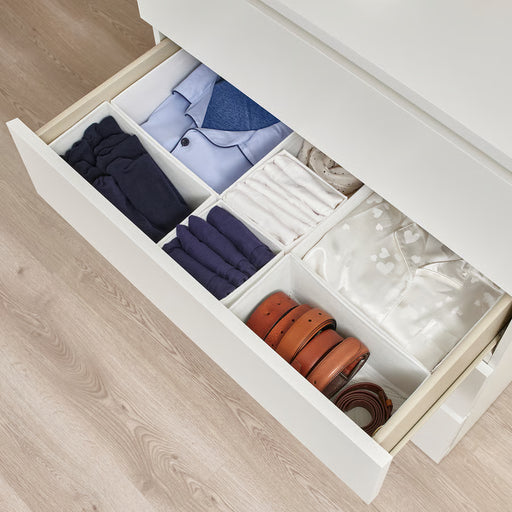 IKEA SKUBB white boxes organising folded clothes belts and accessories inside an open drawer
