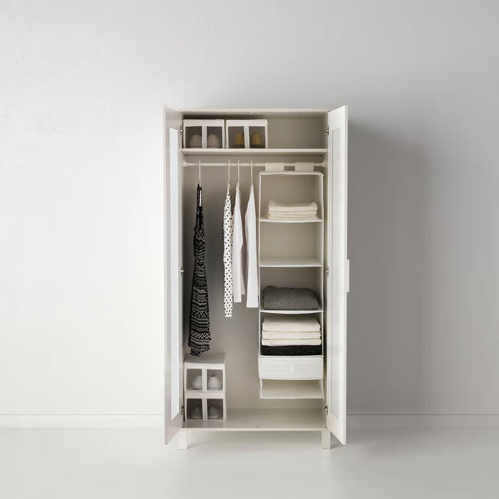 White wardrobe interior with IKEA SKUBB compartment boxes neatly stacked for clothing storage