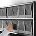 Hand pulling IKEA SKUBB dark grey shoe box from wardrobe shelf showing easy access mesh front