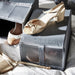 Gold heels placed on top of open IKEA SKUBB dark grey mesh shoe box