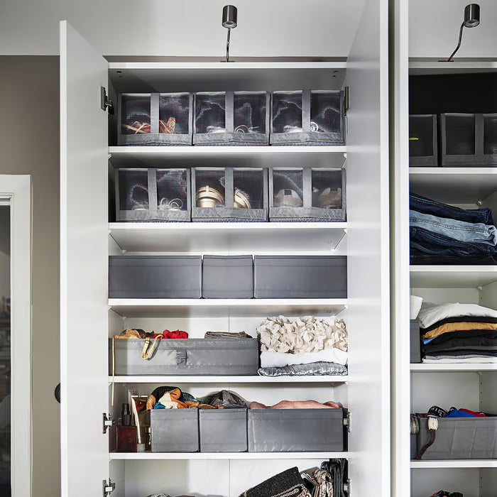 White wardrobe with IKEA SKUBB dark grey shoe boxes arranged neatly on shelves