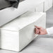Hand pulling out IKEA SKUBB white storage case from under the bed using its built-in handle