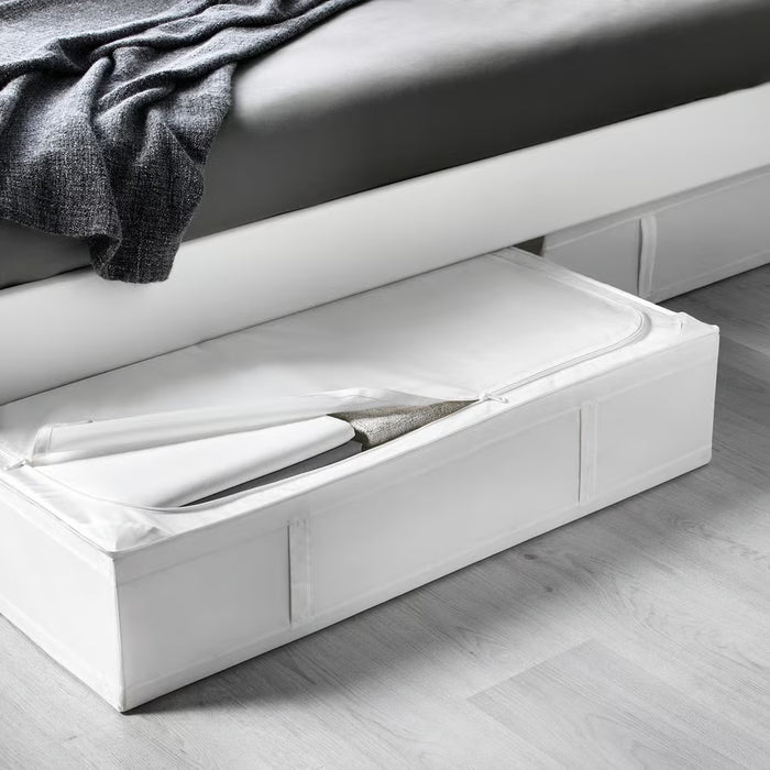 IKEA SKUBB white storage case open under bed with folded blankets and seasonal bedding inside