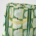 Close-up of IKEA SKYNKE pale yellow bag showing recycled polyester fabric texture and print