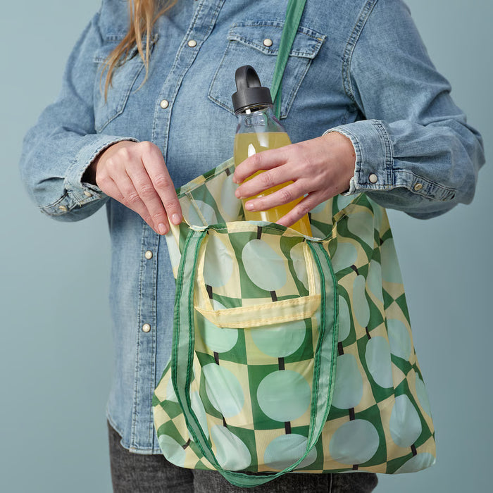 IKEA SKYNKE pale yellow bag worn over shoulder showing long shoulder strap