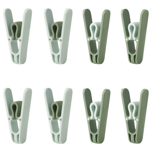 Green IKEA SLIBB clothes peg made of durable plastic.