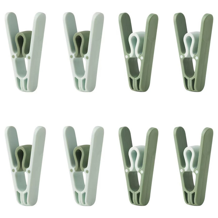 Green IKEA SLIBB clothes peg made of durable plastic.