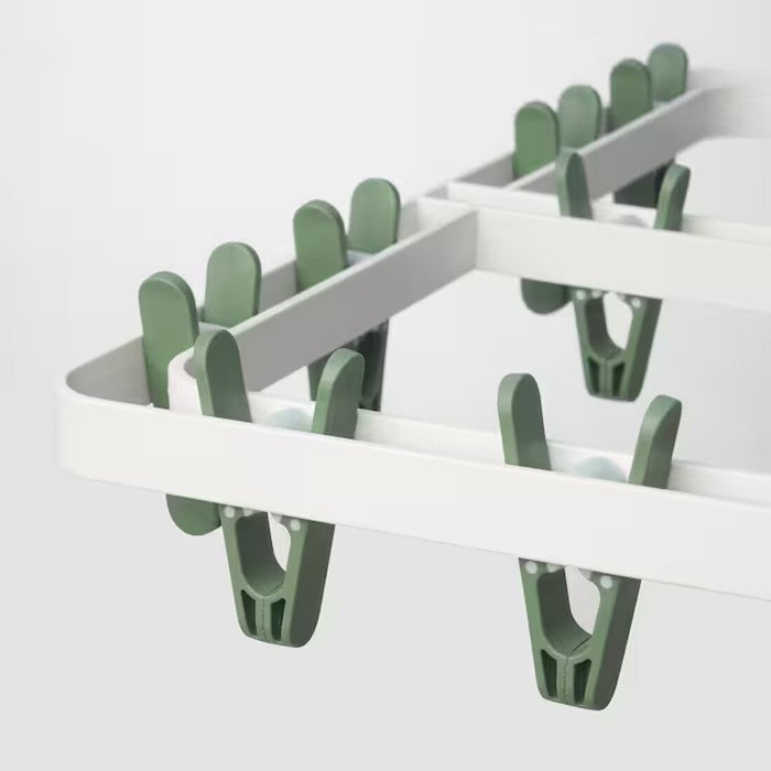 close-up image of the adjustable clothes pegs: "Adjustable clothes pegs on IKEA SLIBB Hang Dryer for versatile drying options