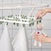 a photo of the hang dryer with clothes hanging: "24 clothes pegs on IKEA SLIBB Hang Dryer in action, providing ample space for air-drying garments