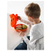 Child opening IKEA SMASKA orange lunch box with sandwich and apple inside