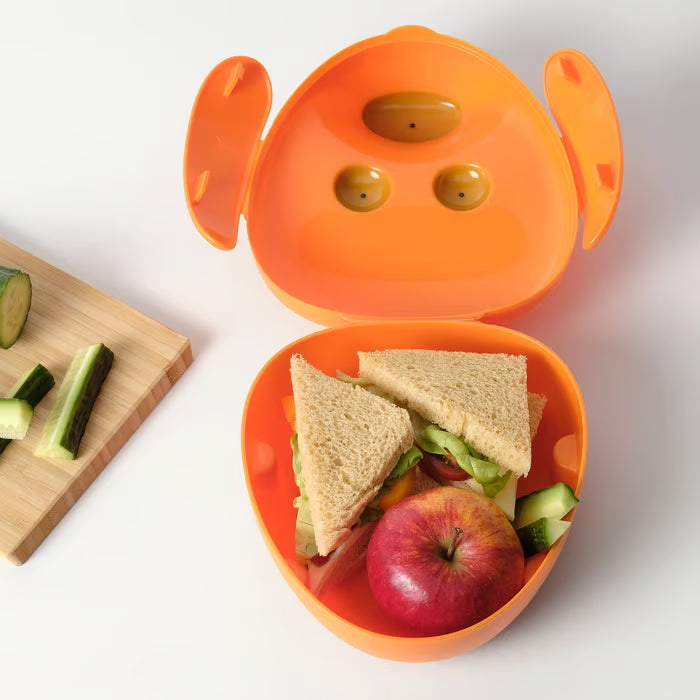  IKEA SMASKA orange kids lunch box open showing sandwich, apple and cucumber slices with ear-shaped lid